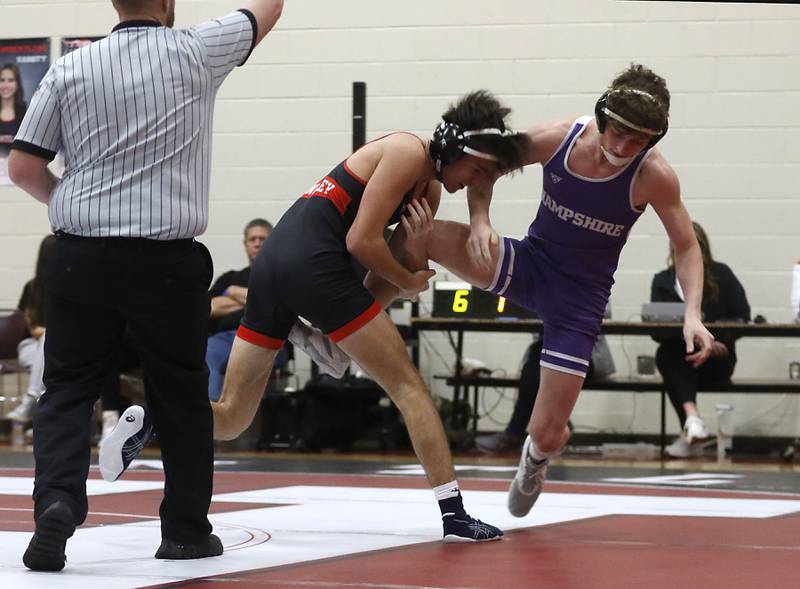 Huntley’s Joe Servedio tries to take down Hampshire's Tyler Marino during the 144-pound match of a Fox Valley Conference wrestling match Wednesday, Jan. 24, 2024, at Huntley High School.