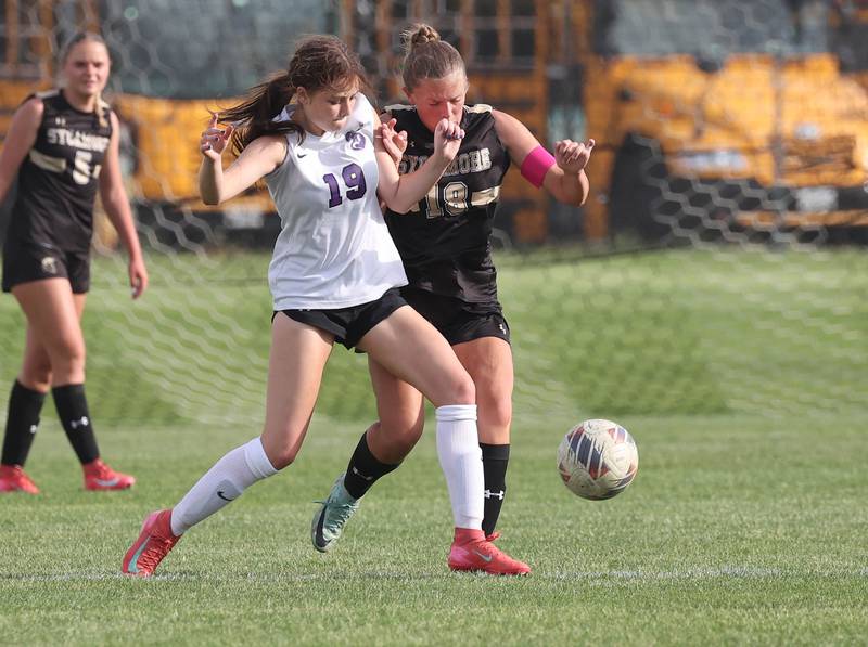 Dixon’s Adysen Johnson and Sycamore's Taylor Zemanek collide as they reach the ball at the same time during their game Thursday May 15, 2025, at Sycamore High School.