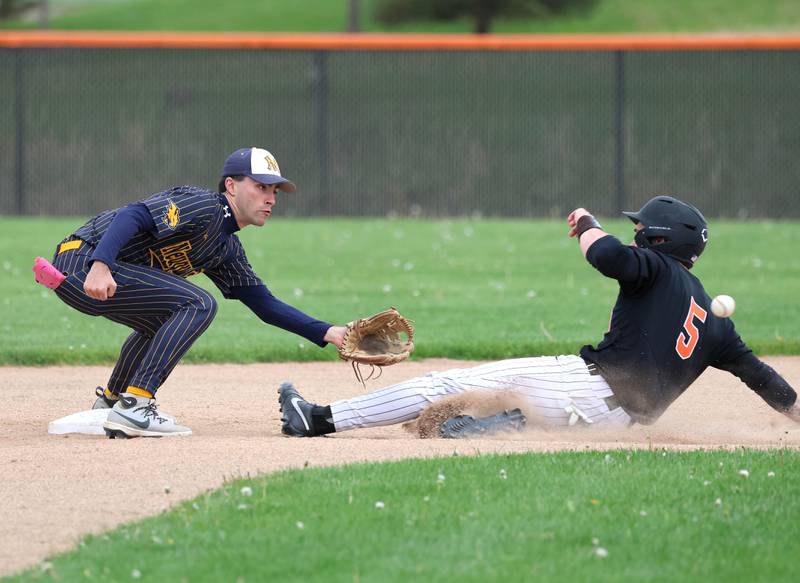 DeKalb's Cole Latimer slides in just ahead of the throw to Neuqua Valley's Kaeden Kraemer Tuesday, May 5, 2026, during their game at DeKalb High School.