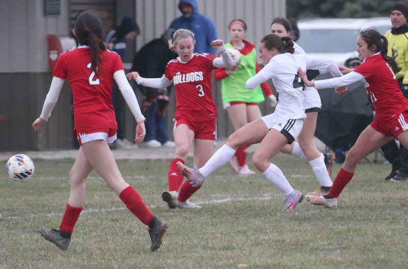 L-P's Brooklyn Ficek (center) kicks the ball past Streator's Joey Puetz as she is pushed from behined by teammate Ophie Orozco on Friday, March 24, 2023 in Streator.