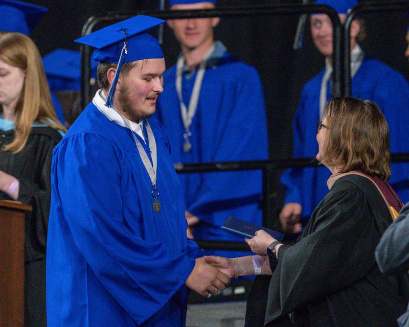 A St. Charles North graduate accepts his diploma on Monday, May 18,, 2026, at a ceremony held at the NIU Convocation Center in DeKalb.