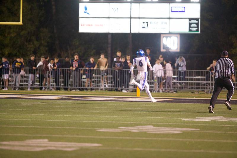 St. Charles North's Keaton Reinke runs in for a touchdown against Wheaton Warrenville South on Friday, Oct. 10, 2025 in Wheaton.
