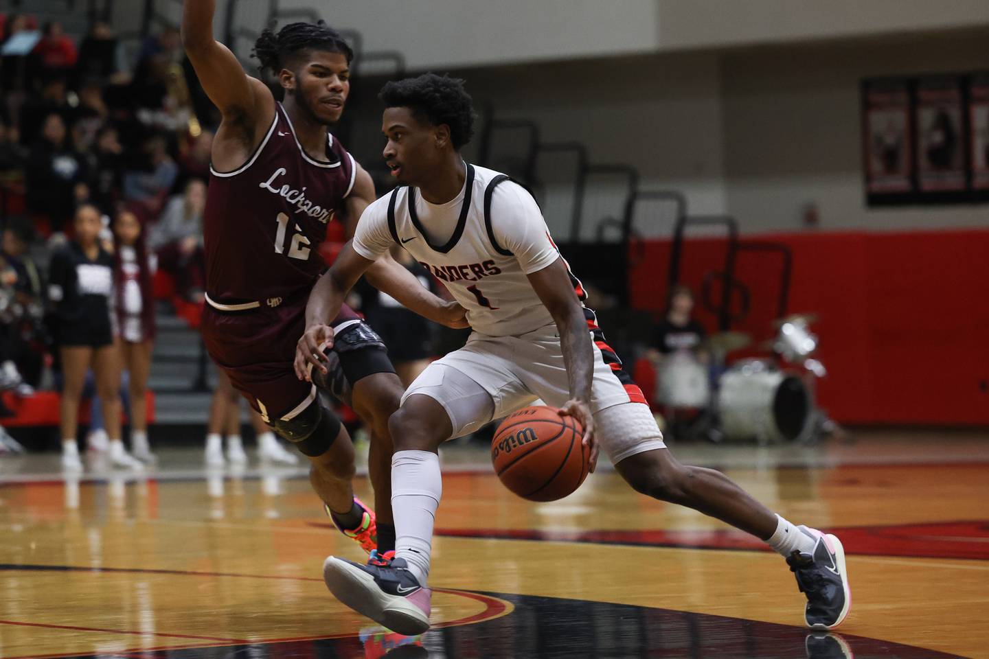 Bolingbrook’s Mekhi Cooper works around Lockport’s Jalen Falcon on Friday, February 10th.