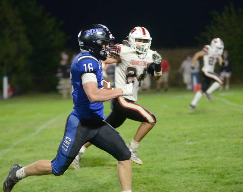 Eastland-Pearl City's Brecken Hayden (16) heads to the end zone as Forreston's Mickey Probst (24) tries to catch him during Friday, Oct. 3, 2025 action at Pearl City High School.