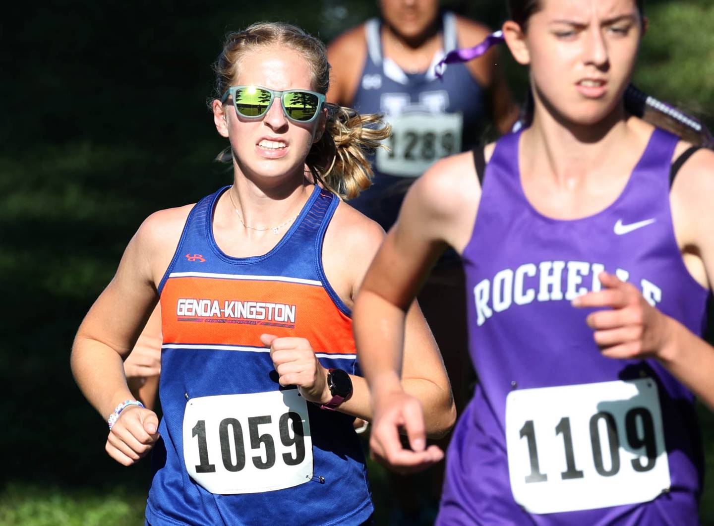 Genoa-Kingston’s Emma James (left) runs the girls varsity race Tuesday, Sept. 3, 2024, at the Sycamore Cross Country Invite at Kishwaukee College in Malta.