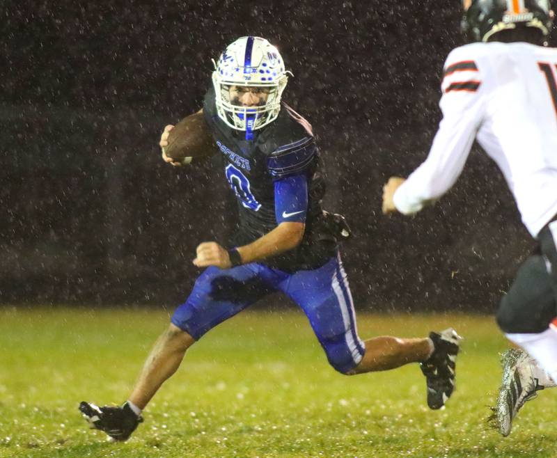 Burlington Central’s Henry Deering moves the ball against Harlem in IHSA football Class 6A second-round playoff action at Central High School in Burlington on Saturday, November 8, 2025.