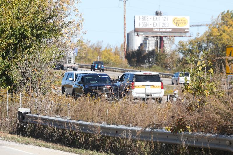 State police sit along an empty southbound I-55. A crash involving two semitrailers shutdown down southbound I-55 as diesel fuel, water bottles and soybeans covered all lanes of Interstate 55 south of the I-80 interchange early Wednesday morning.