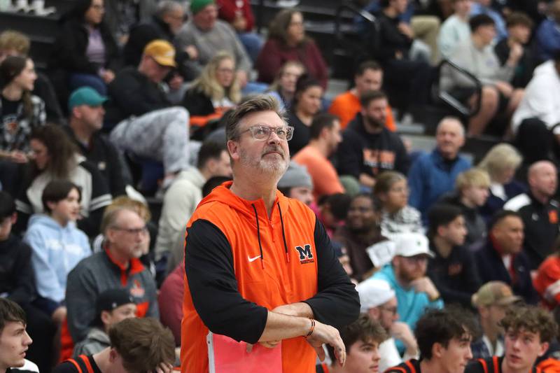 McHenry’s Head Coach Corky Card peeks at the scoreboard late in a loss to Warren in IHSA Class 4A Regional Title Game boys basketball action on Friday, Feb. 28, 2025 at McHenry High School in McHenry.