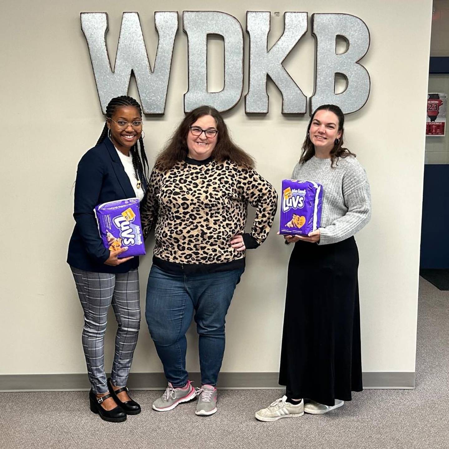 (From left) Malia Jones, founder of The Breakroom and Friends LLC, WDKB 94.9 Radio host Peyton Adams and Kendall Hampton, founder of Empower Parenthood Project pose with diapers while promoting an upcoming community diaper drive.

Empower Parenthood Project (EPP), a local nonprofit, is teaming up with The Breakroom and Friends and other organizations for a special event A Date with Dignity on Dec. 16, 2023. The diaper drive runs through Dec. 11, 2023.