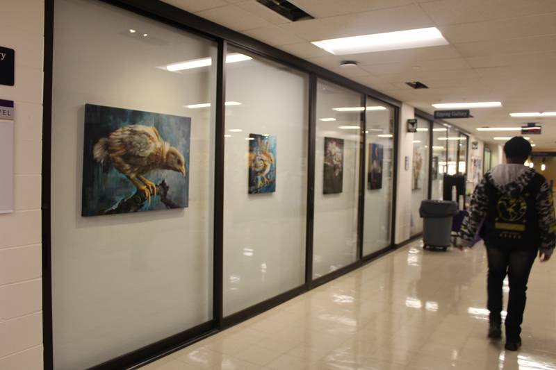 A student walks down the hall of MCC past the Epping Gallery that features work by Crystal Lake resident Karl Jahnke.