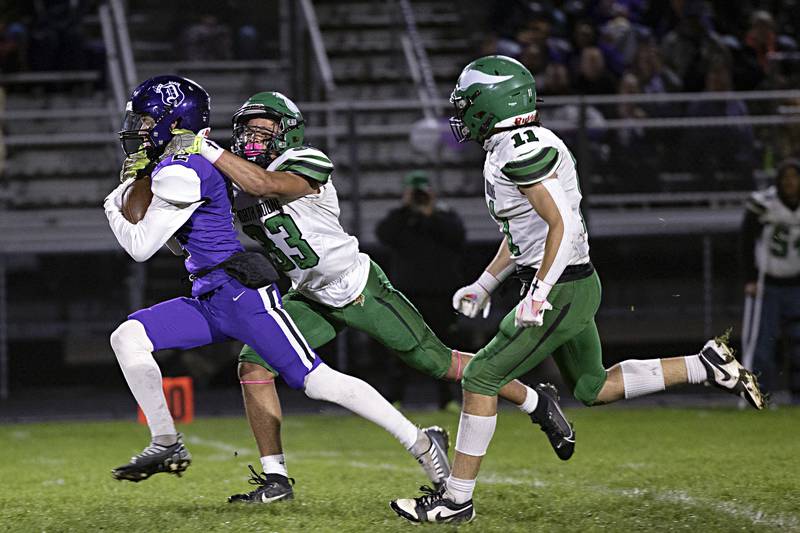 Dixon’s Cullen Shaner is hauled down by North Boone’s Azriel Dixon Friday, Oct. 20, 2023 in Dixon.