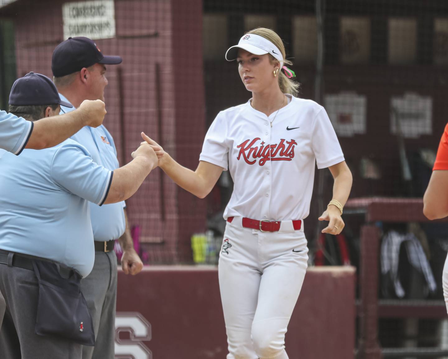 Lincoln-Way Central's Lisabella Dimitrijevic (13) greets the umpire crew before their Class 4A Lockport sectional softball matchup against Lincoln-Way West on Tuesday, June 3, 2025 in Lockport.