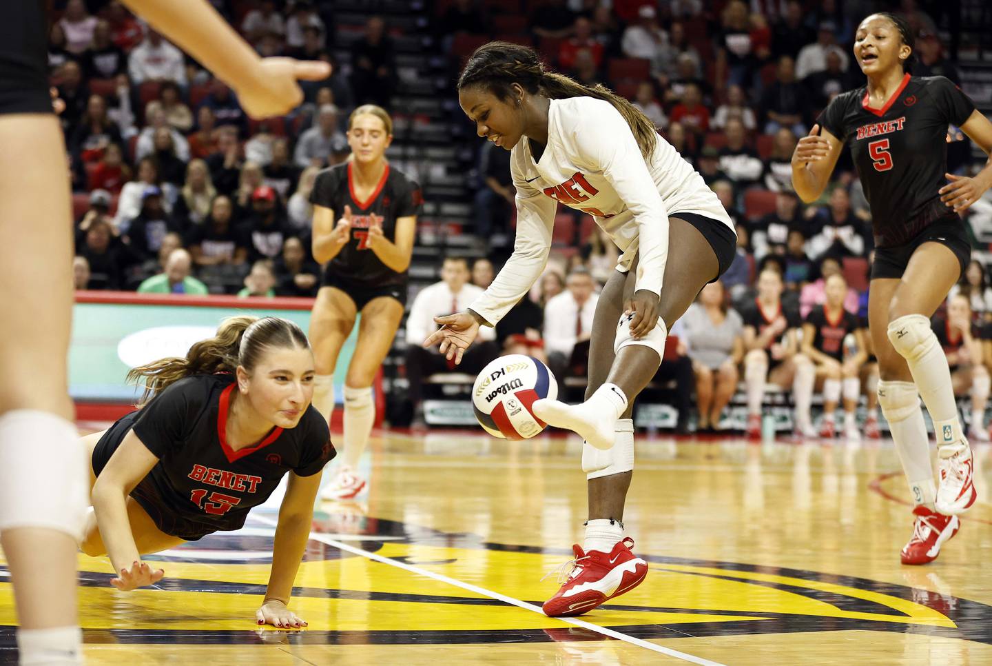 Benet Academy's Aniya Warren (8) looses her shoe after attempting to save a point during the IHSA Class 4A girls volleyball championship match Saturday, Nov. 16, 2024 at CEFCU Arena in Normal.
