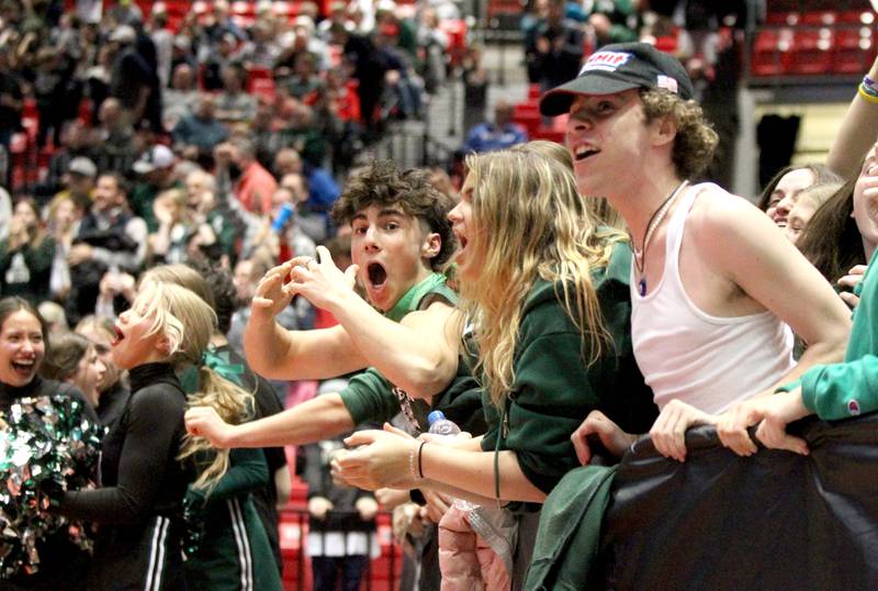 Glenbard West’s fan section goes crazy after Bobby Durkin’s half court shot on the buzzer to end the third quarter during a Class 4A DeKalb Supersectional game against Larkin at the Northern Illinois University Convocation Center on Monday, March 7, 2022.
