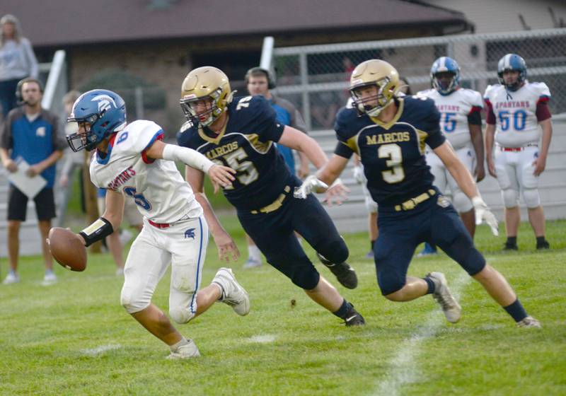 Polo's Wyatt Plachno (75) and Damon Rowe (3) flush the Bushnell-Prairie City quarterback out of the pocket during 8-man action on Friday, Aug, 29, 2025 in Polo.