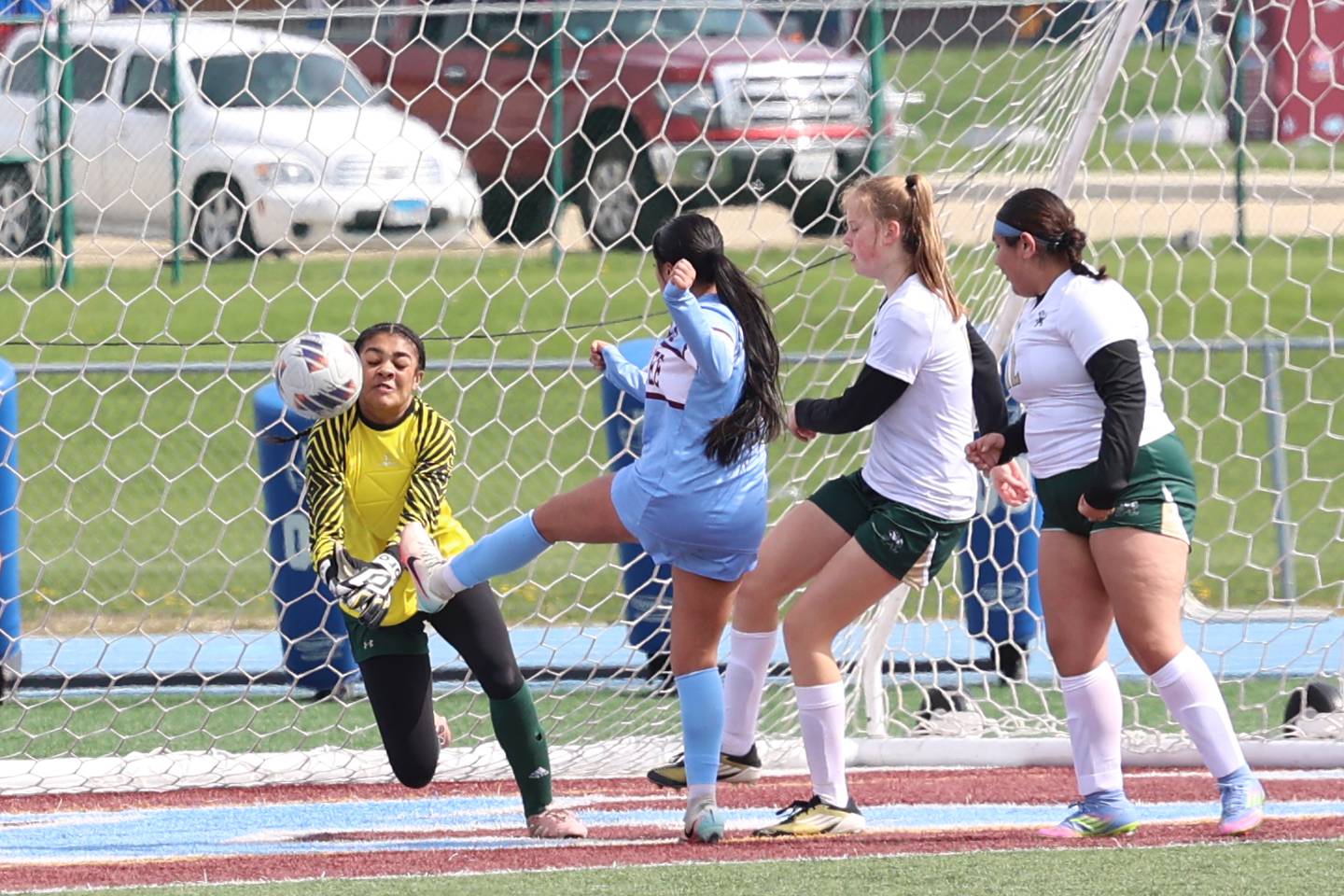 Bishop McNamara goalkeeper Kaneyce Davis deflects a shot by Kankakee's Yailen Torres during the Kays' 8-0 victory in the final All-City match on Saturday, April 11, 2026.