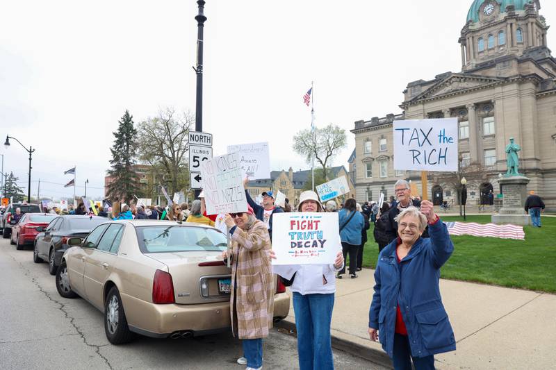 Protesters hold signs alongside over 250 fellow demonstrators during the Hands Off Rally at the Kankakee County Courthouse on Saturday, April 19, 2025.