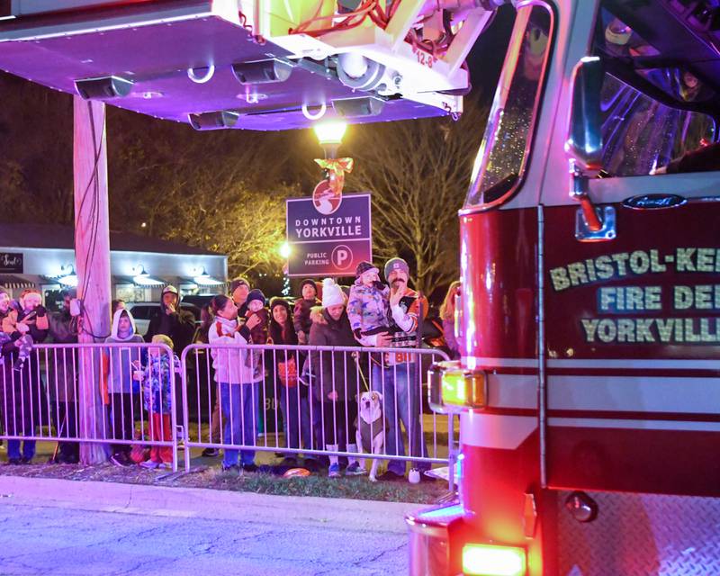 Community members line E. Hydraulic St. for the tree lighting parade that took place Friday Nov. 21, 2025, near Riverfront Park in Yorkville.