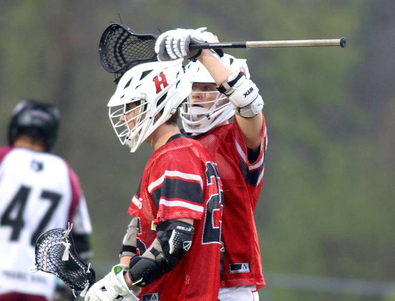 Huntley’s  Bobby Pupich, front, is greeted by teammate Joey Ferrara after a Red Raider goal in varsity boys lacrosse at Prairie Ridge  High School in Crystal Lake on Thursday, May 1, 2025.