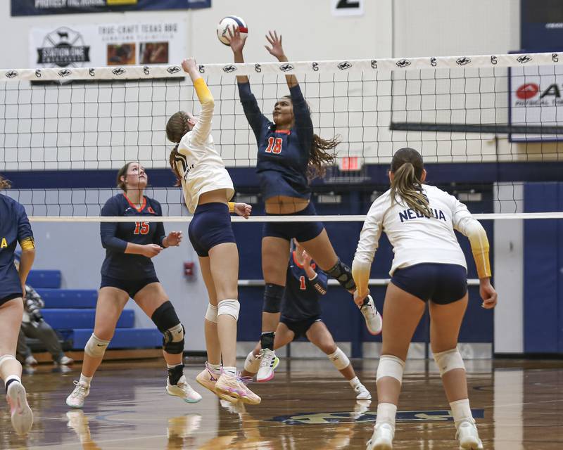 Oswego's Maya Norlin (18) attempts a block at the net during Class 4A Regional Final volleyball match between Neuqua Valley at Oswego. Oct 30, 2025 in Plainfield.