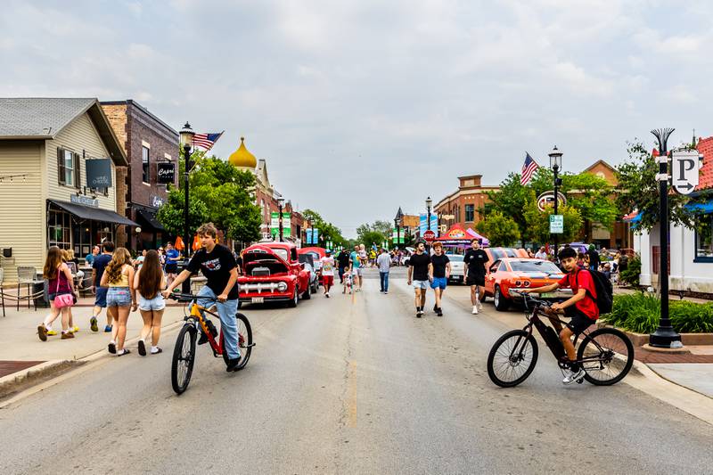 Attendees enjoy checking out the classic cars on Lockport Street during the first Plainfield Cruise Night of the season on June 3, 2025.