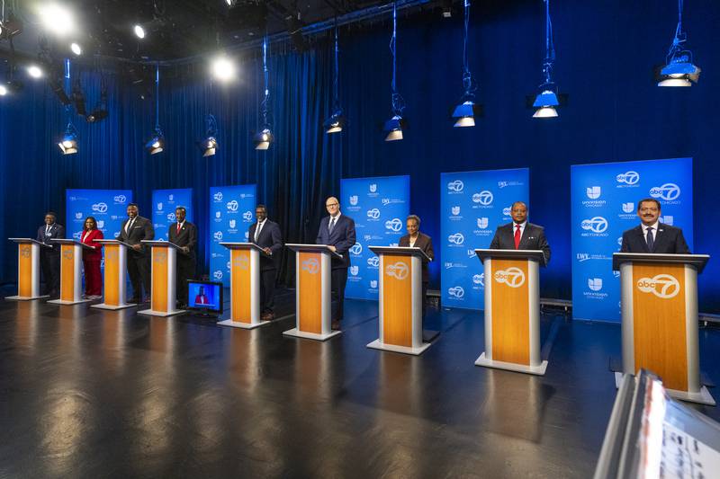 From left, Chicago mayoral candidates Ja'Mal Green Sophia King, Kam Buckner, Wille Wilson, Brandon Johnson, Paul Vallas, current Mayor Lori Lightfoot, Roderick Sawyer and Jesus "Chuy" Garcia get ready to debate one another at WLS-TV ABC Channel 7's studio, Thursday, Jan. 19, 2023, in Chicago.