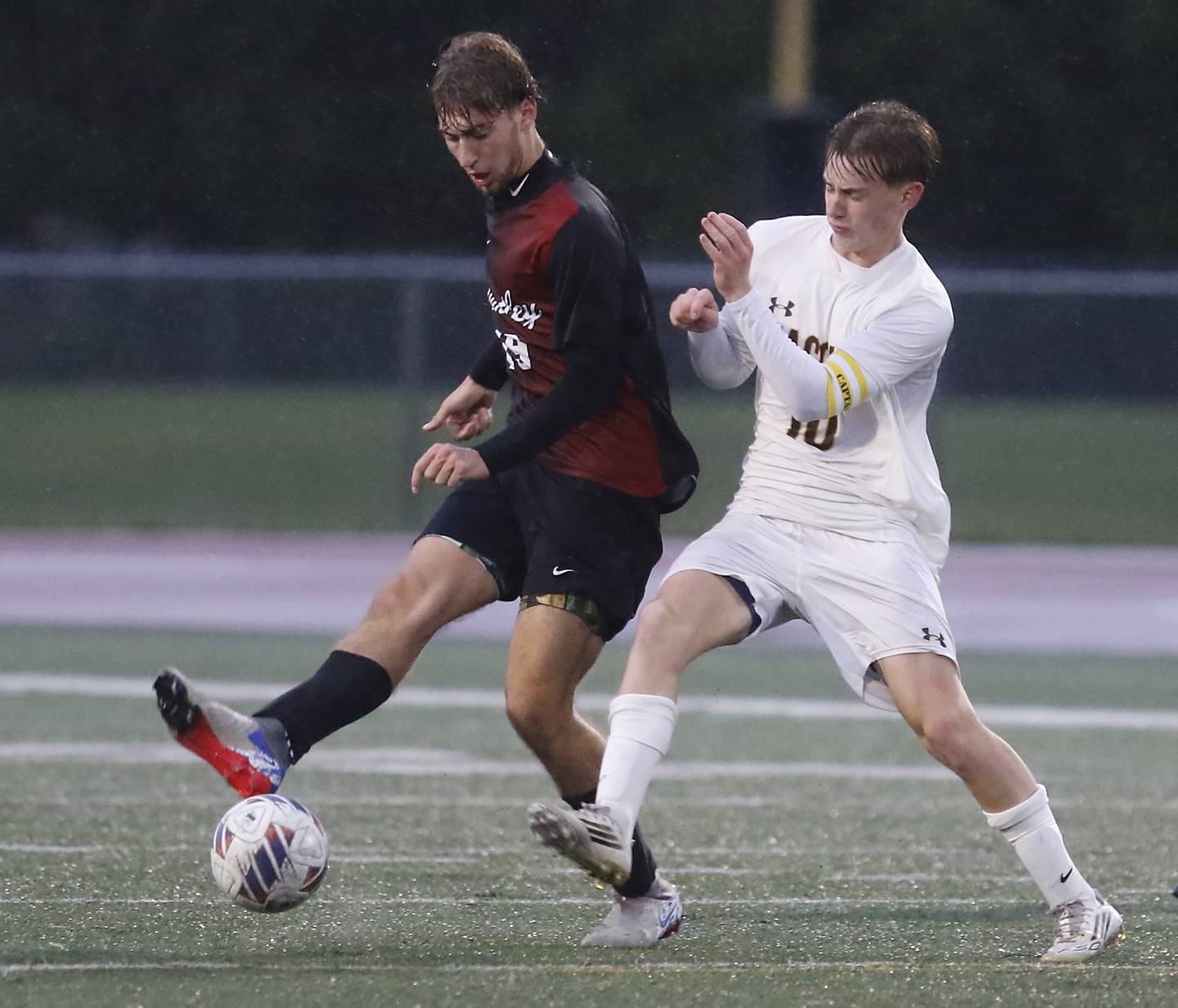 Huntley's Liam Nixon passes the ball as he is defended by Jacobs' Jackson Foley during an IHSA Class 3A Huntley Regional boys soccer semifinal match on Tuesday, Oct. 21, 2025, at Huntley High School.