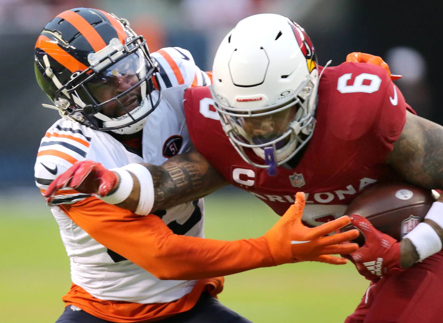 Chicago Bears cornerback Jaylon Johnson wraps up Arizona Cardinals running back James Conner during their game Sunday, Dec. 24, 2023, at Soldier Field in Chicago.