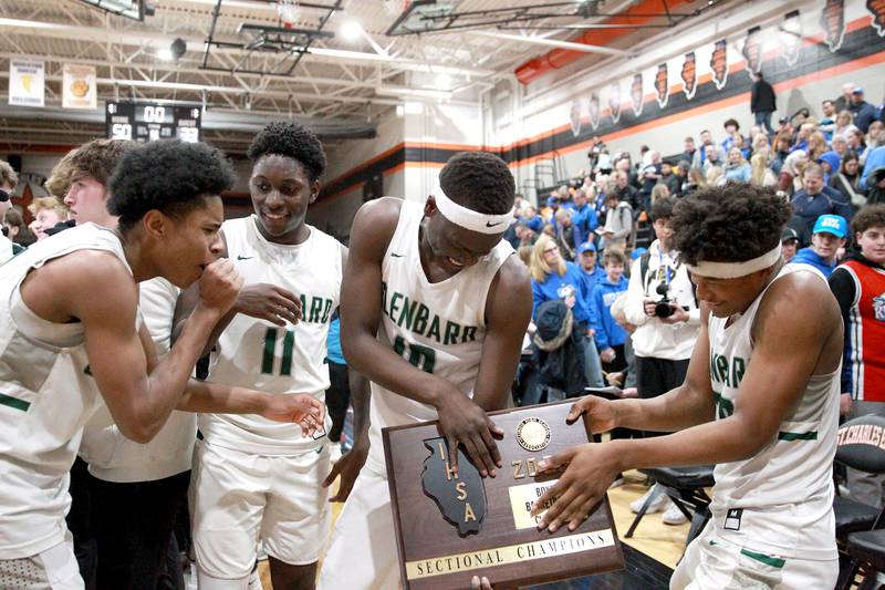 (Left to right) Glenbard West's TJ Williams, Teyion Oriental, Josh Abushanab and Logan Glover celebrate following their Class 4A St. Charles East Sectional final win over Geneva on Friday, March 7, 2025 in St. Charles.