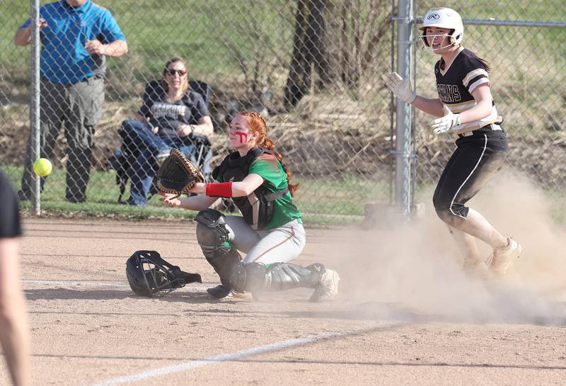 LaSalle-Peru's Addison Duttlinger takes the late throw as Sycamore's Tia Durst celebrates after scoring the game’s first run during their game Tuesday, April 11, 2023, at Sycamore High School.