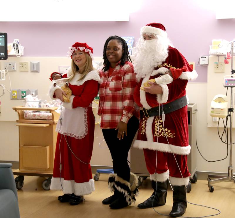 Keena Young of Oswego and her newborn twin daughters, Eva and Ava, get a visit from Santa and Mrs. Claus in the NICU at Northwestern Medicine Central DuPage Hospital in Winfield on Wednesday, Dec. 20, 2023.