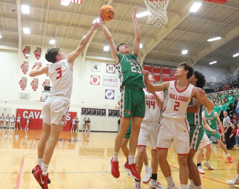 L-P's Nick Olivero grabs a rebound over Streator's Noan Ketcham and Matt Williamson during the Class 3A Regional title game on Friday, Feb. 28, 2025 in Sellett Gymnasium at L-P High School.