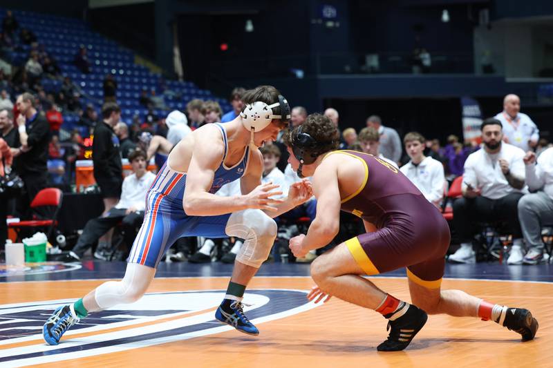 Marmion Academy's Ashton Hobson, left, lunges toward Montini's Will Konder in the 157-pound match during Marmion Academy's victory over Montini in the IHSA Class 3A Dual Team State championship on Saturday, Feb. 28, 2026.