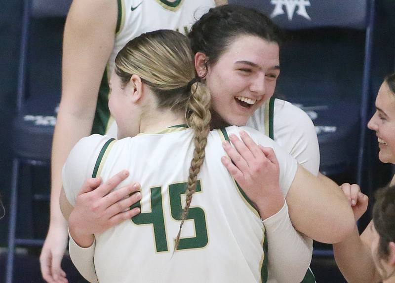 St. Bede's Ali Bosnich hugs St. Bede's Savannah Bray after winning the Class 1A Regional semifinal game over Marquette on Monday, Feb,. 12, 2024 in Bader Gym.