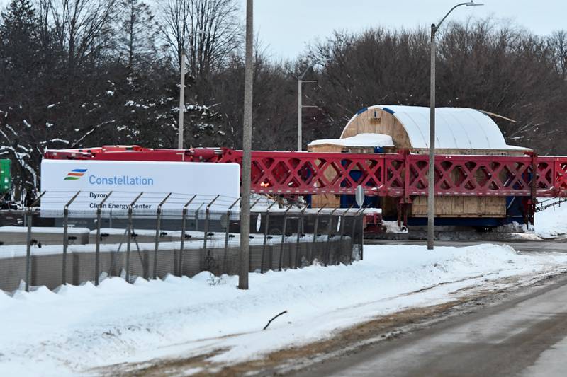 The tractor and trailer pulling and pushing one of the large turbines turns in at the main entrance for Constellation's Byron generating station on Monday, Dec. 8, 2025.