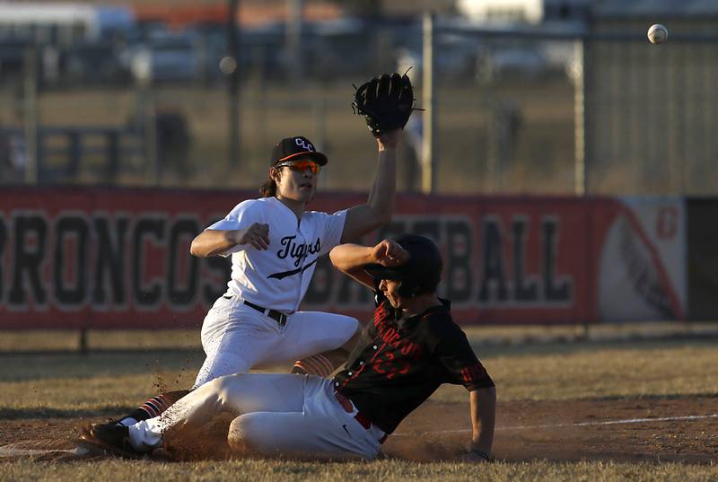 Barrington’s Nick Lacson slides into third as Crystal Lake Central’s Braydon Gibour waits for the throw during a non-conference baseball game Tuesday, March 15, 2022, between Crystal Lake Central and Barrington at Barrington High School.