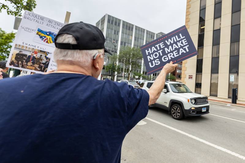 An attendee holds up a sign at the Good Trouble Lives On event in Downtown Joliet on July 17, 2025.