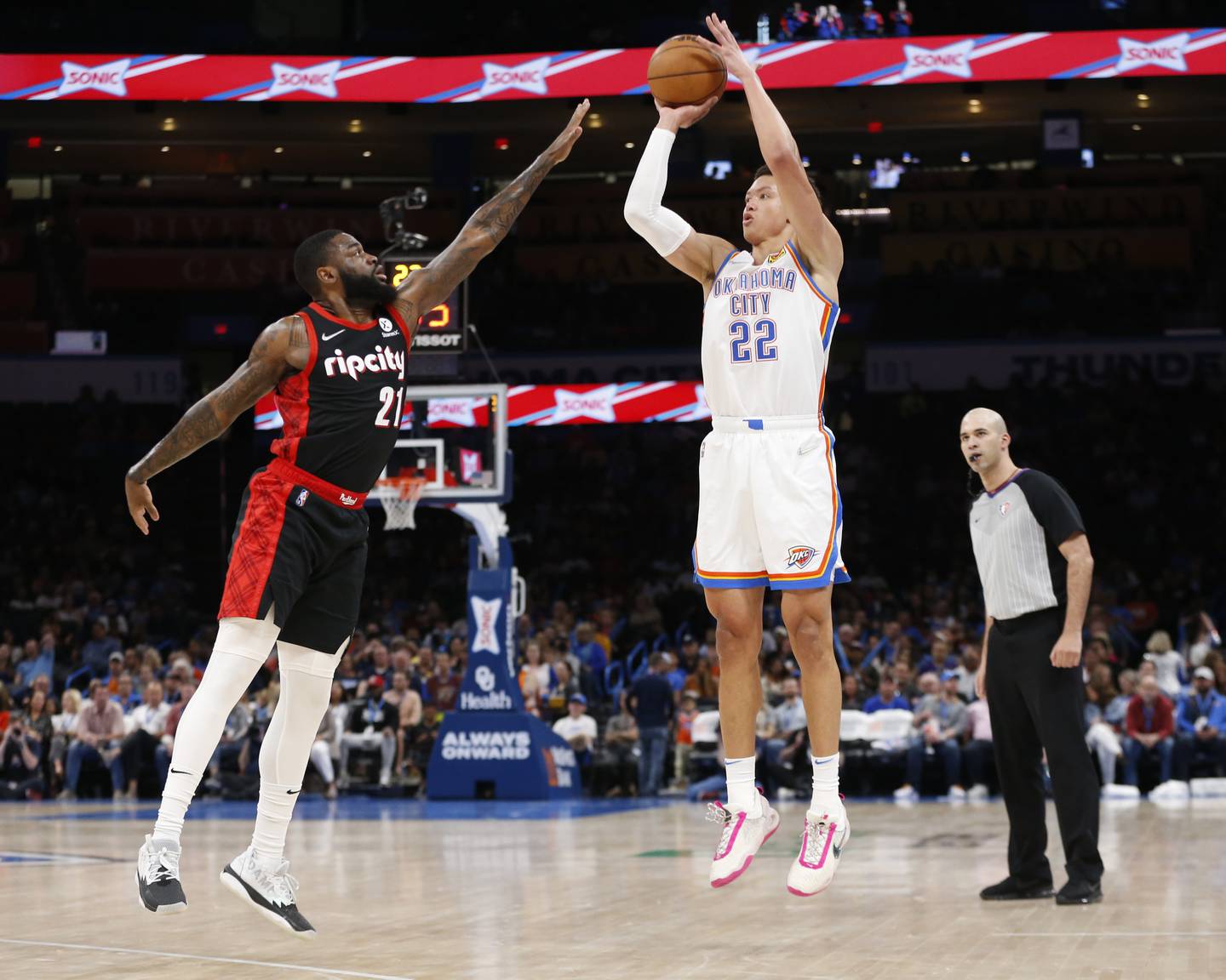 Oklahoma City Thunder forward Isaiah Roby (22) shoots over Portland Trail Blazers forward Keljin Blevins (21) during the second half Tuesday, April 5, 2022, in Oklahoma City. (AP Photo/Garett Fisbeck)