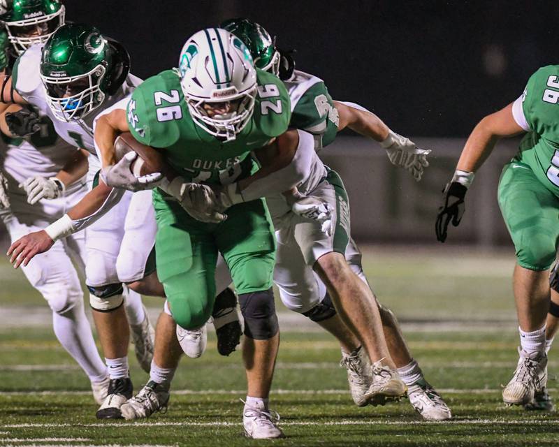 York's Henry Duda (26) gains some yards before being brought down by Glenbard West's Marc Tchapda (99) during the game on Friday Oct. 17, 2025, held at York High School.