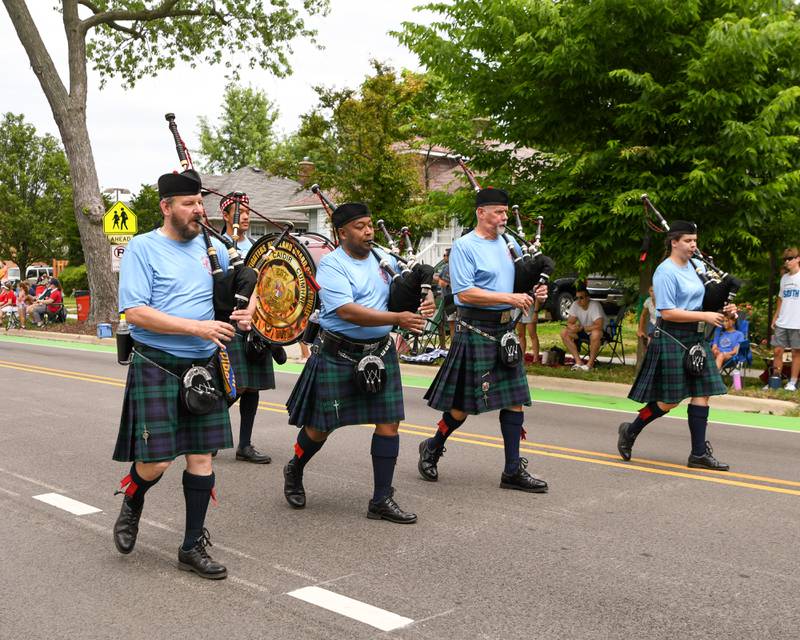 Members of the Firefighters Highland Guard of Naperville Pipes and Drums preform on Friday July 4, 2025, during the Independence Day parade in downtown Downers Grove.
