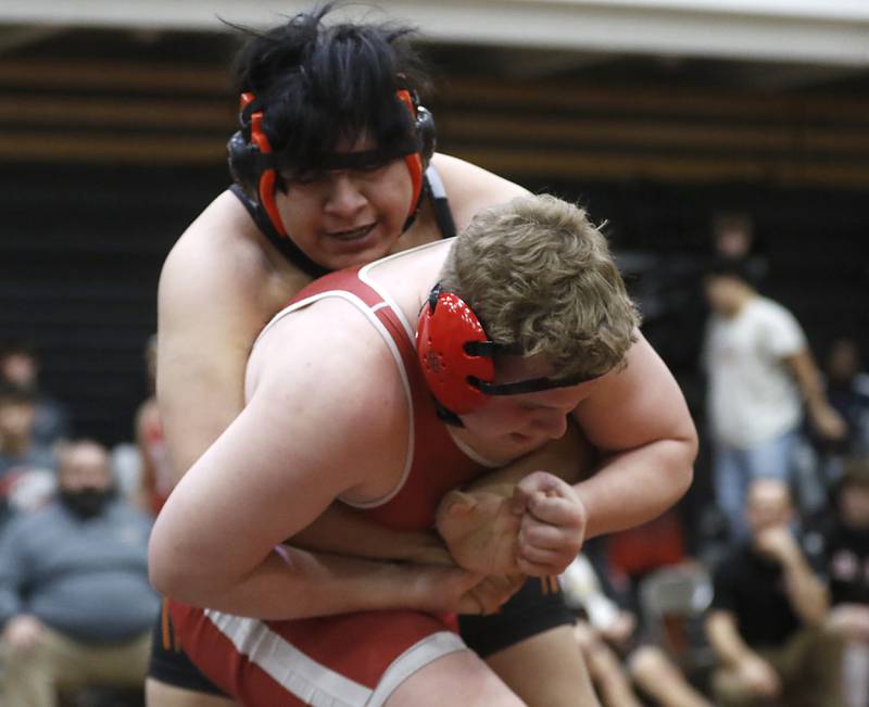 Huntley’s McHenry’s Andy Lara tries to control Huntley’s Dylan Cerny during the 215-pound match of a Fox Valley Conference boys wrestling match Thursday, Jan. 11, 2024, at McHenry High School.