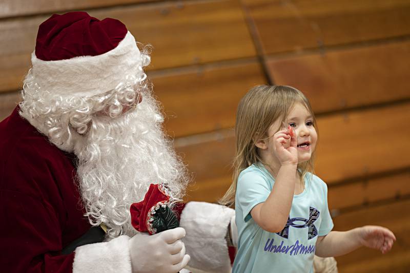 Brynn Sharp, 4, of Tampico shows off her treat Santa gave her Saturday, Dec. 9, 2023 during Tampico’s Christmas in the Country event at the Reagan Community Center.