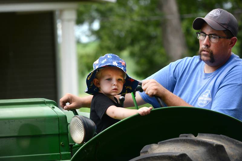 James Green had a little copilot with him as he drove his John Deere tractor in the German Valley Days parade on Saturday, July 19, 2025.