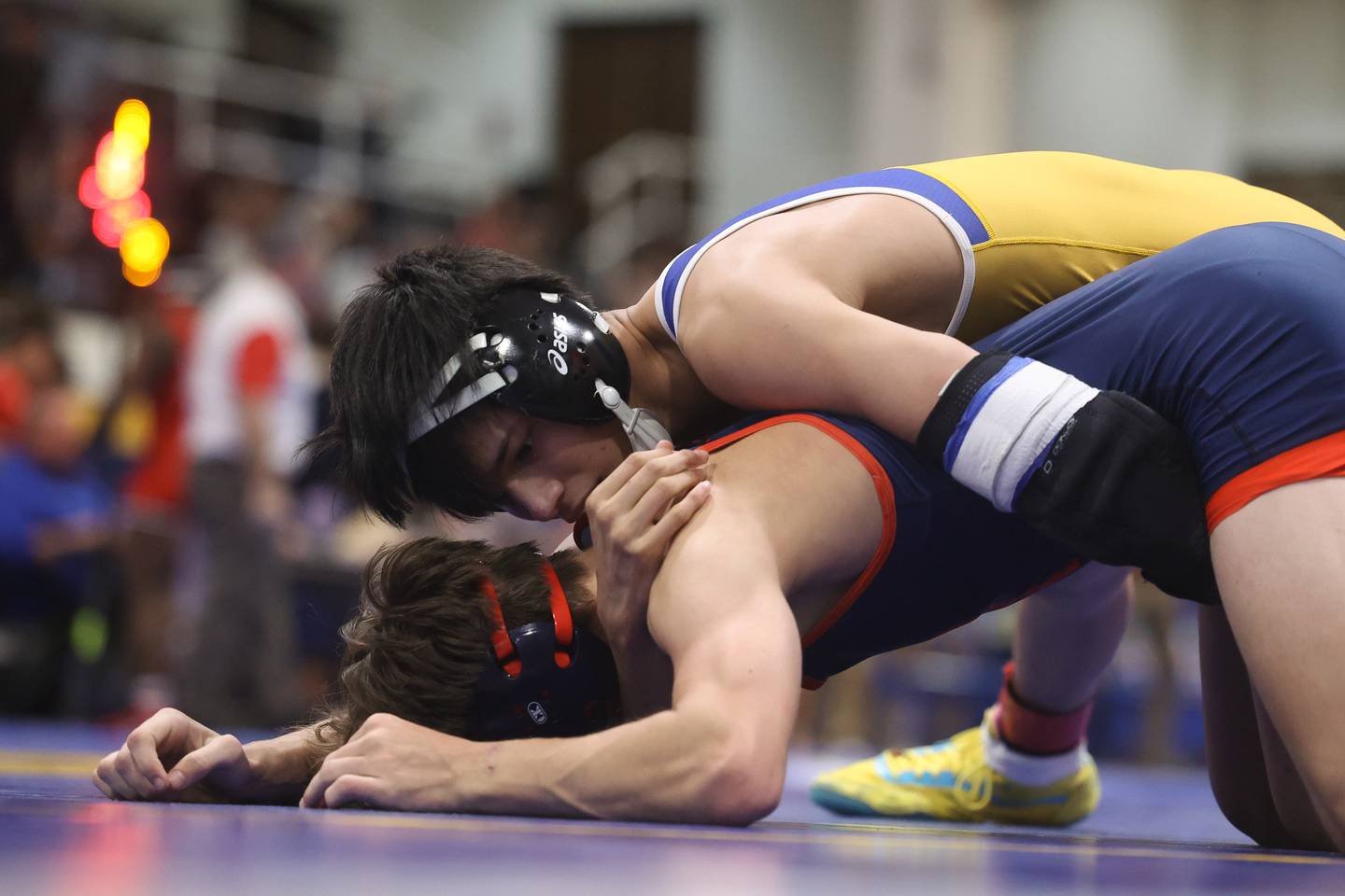 Joliet Central’s Alex Fernandez works overSt. Rita’s Austin Dangles in the 120 pound semifinal at the Joliet Central McLaughlin Classic in Joliet.