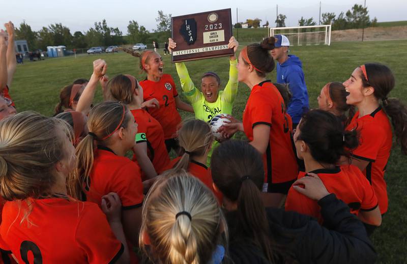 Crystal Lake Central's Addison Cleary lifts the trophy as they celebrate wining IHSA Class 2A Burlington Central Girls Soccer Sectional final match against Boylan Friday, May 26, 2023, at Burlington Central High School.