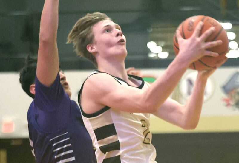 Sycamore's Aidan Wyzard gets past a Plano defender for a layup Tuesday, Jan. 3, 2023, during their game at Sycamore High School.