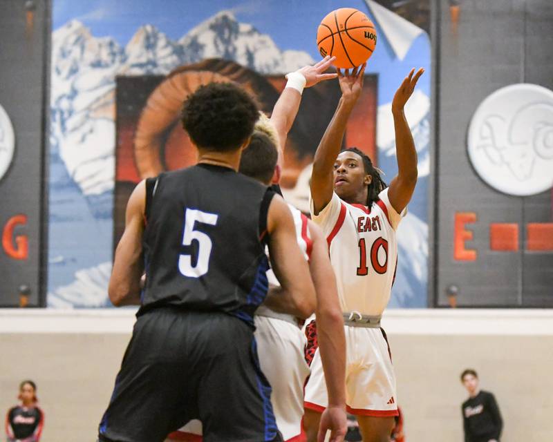 Glenbard East's Cameron Bonner (10) take s a shot during the game while being defended by Riverside Brookfield on Friday Dec. 19, 2025, held at Glenbard East High School.