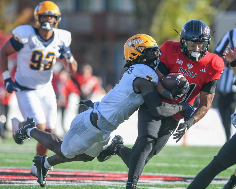 Toledo’s Emmanuel McNeil-Warren brings down Northern Illinois ball carrier Gavin Williams, right, after gaining some yards during the game on Saturday Oct. 19, 2024, held at Northern Illinois University.