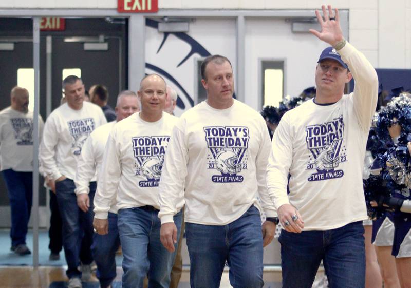 Members of the coaching staff acknowledge the crowd during a celebration of the IHSA Class 6A Champion Cary-Grove football team at the high school Sunday.