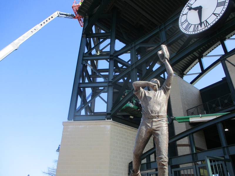 The statue of Jesse Barfield, a Major League Baseball standout from Joliet, is seen with a construction crane in the background for structural steel painting underway at Slammers Stadium in Joliet on Friday. Apirl 11, 2025
